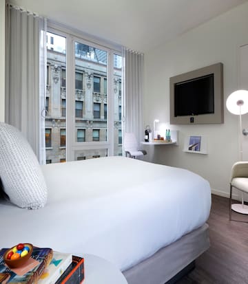 a bedroom with a bed and a television