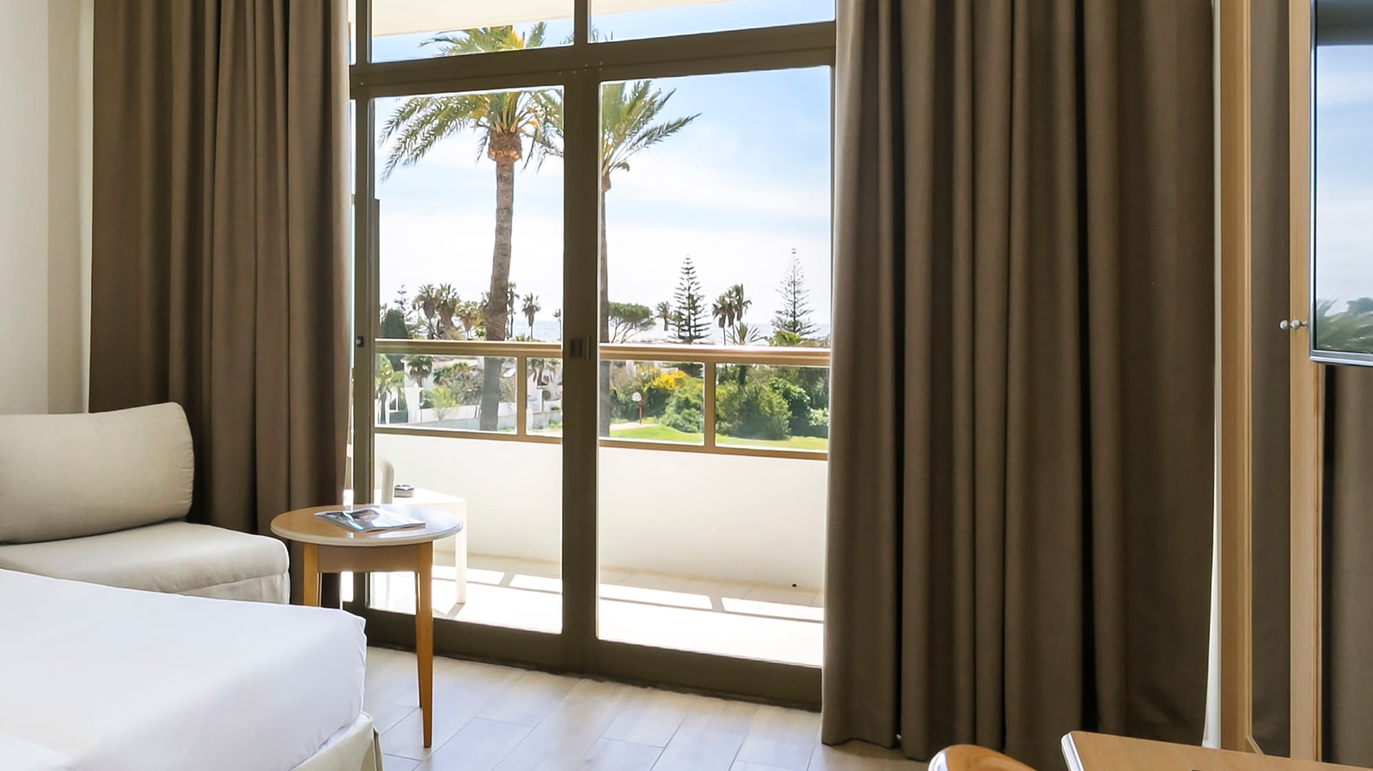 a room with a bed and a table and chairs