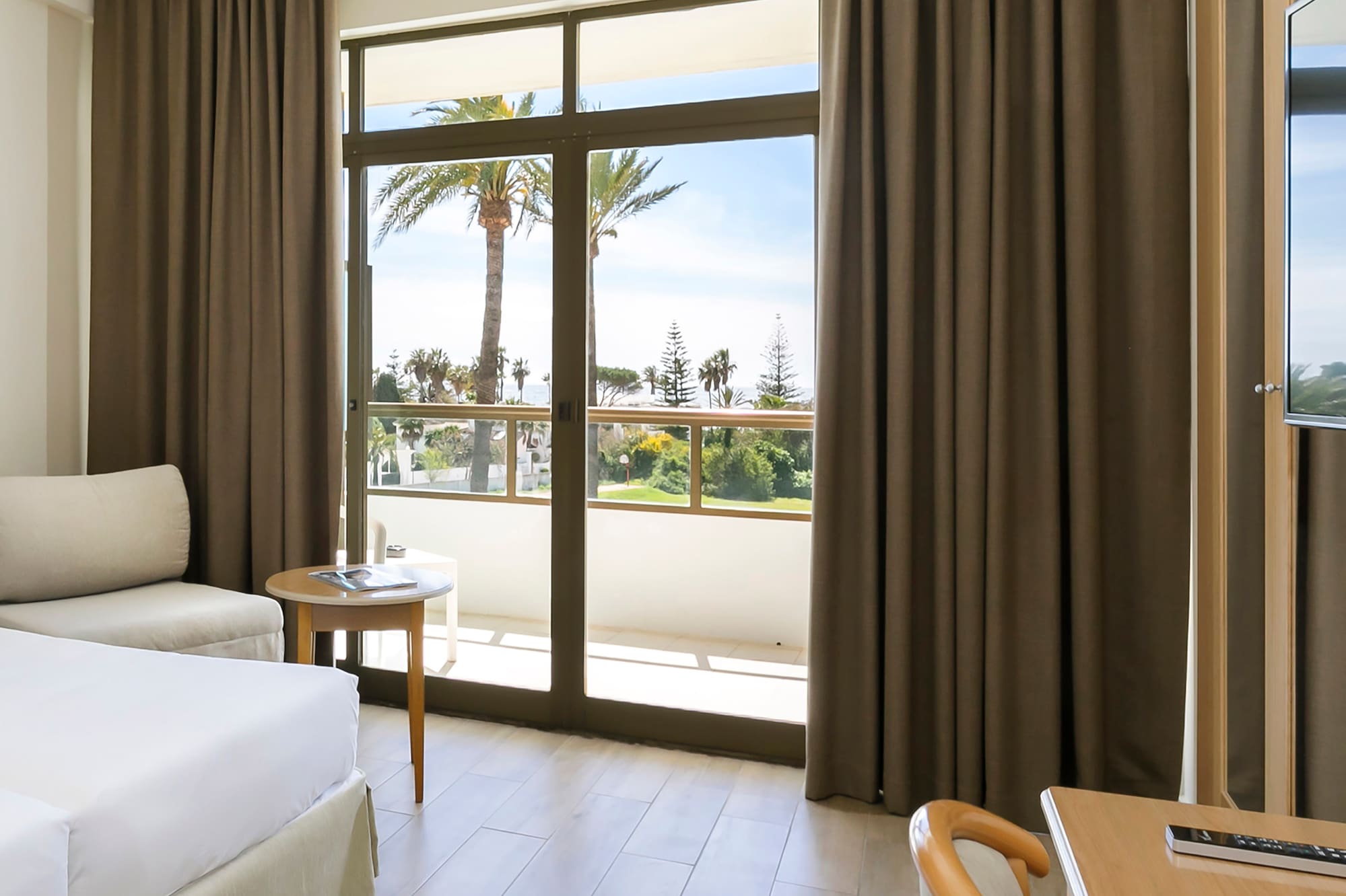 a room with a bed and a table and chairs