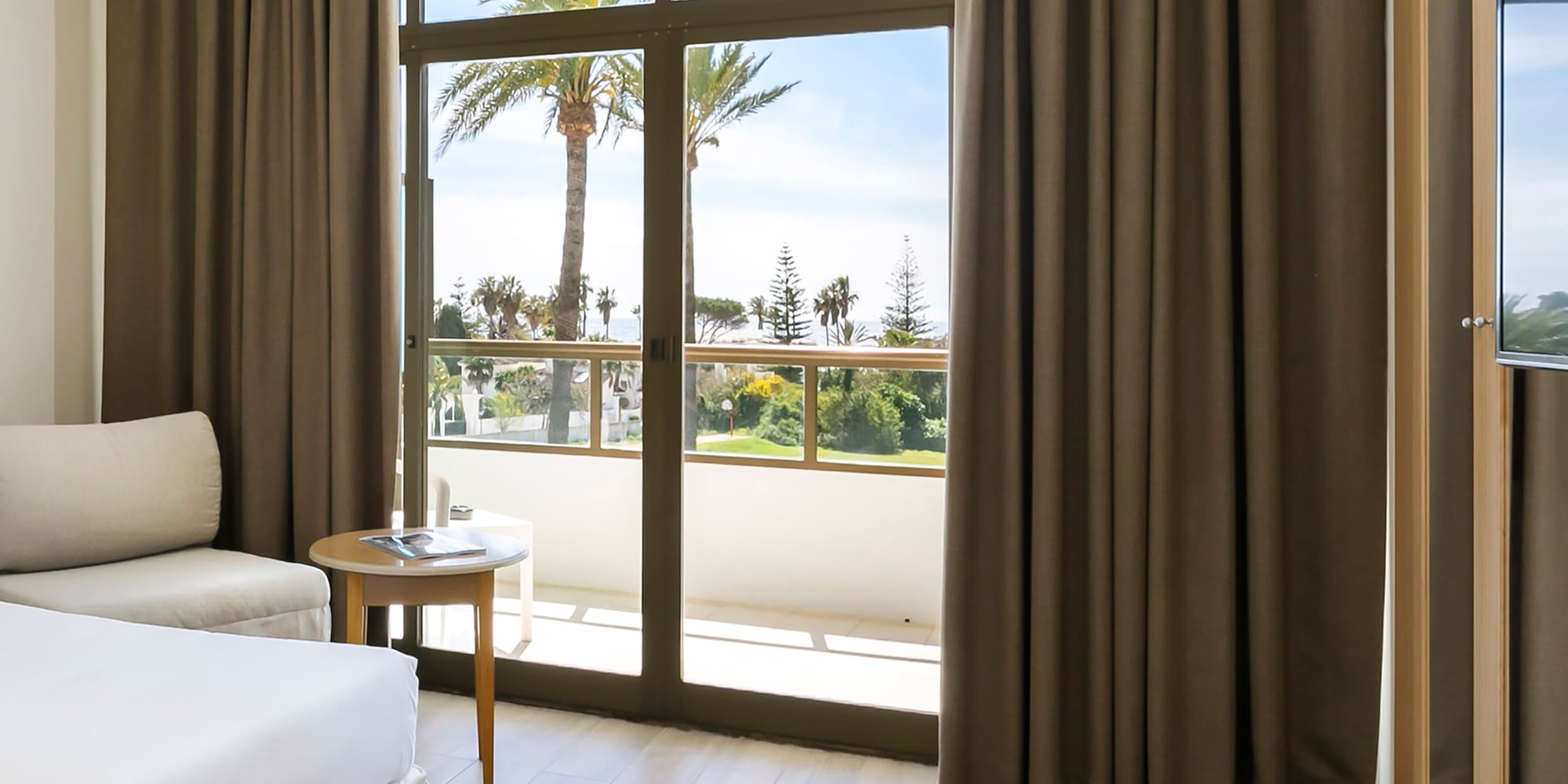 a room with a bed and a table and chairs