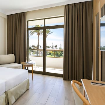 a room with a bed and a table and chairs