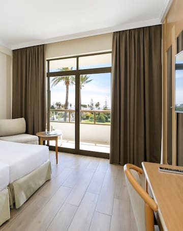 a room with a bed and a table and chairs