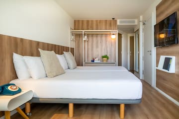 a bed with pillows in a room