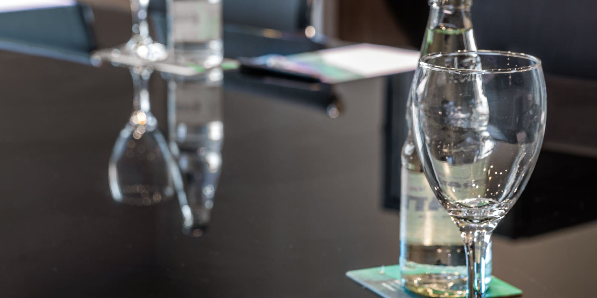 a glass bottle and water on a table