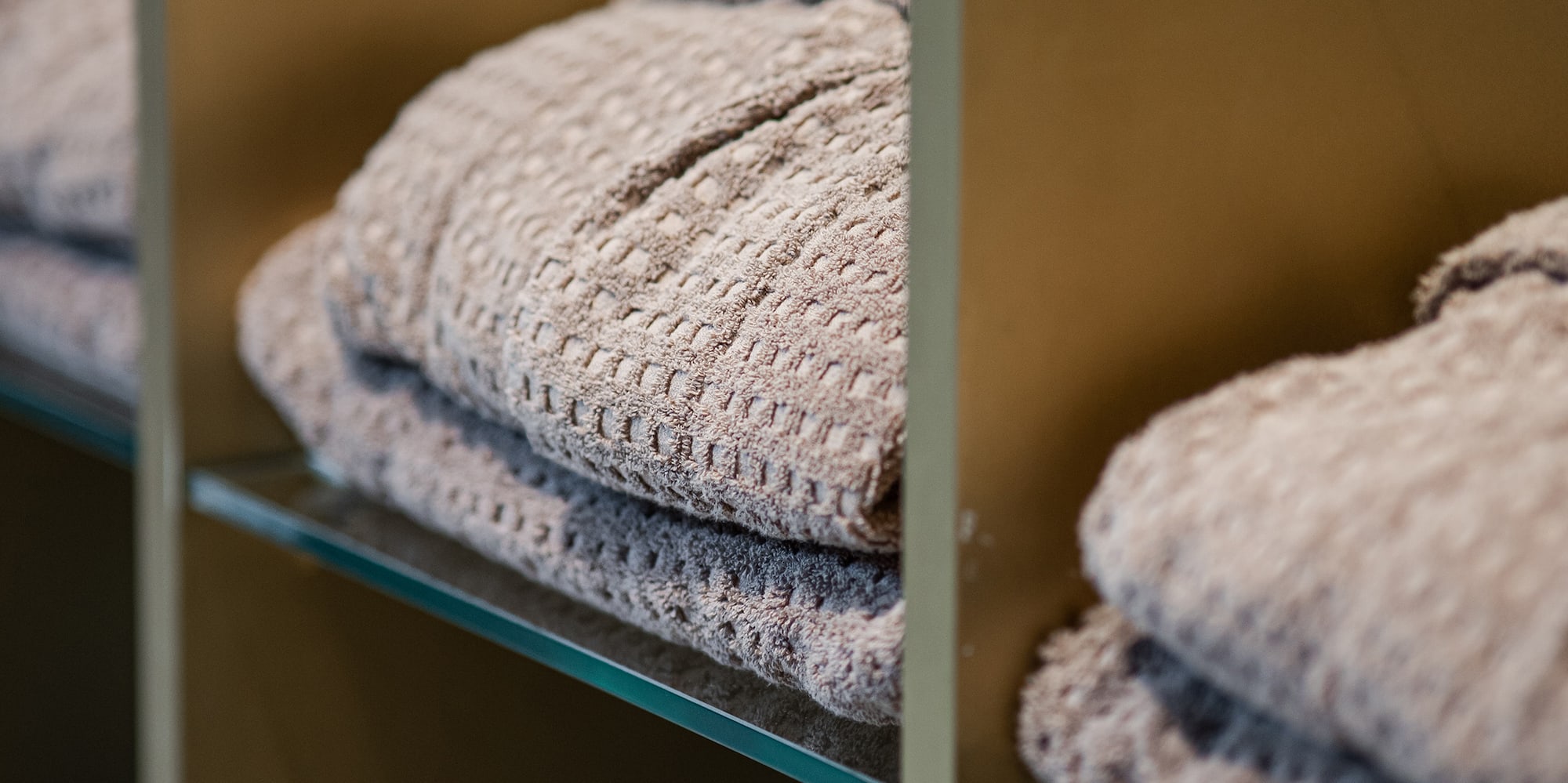 a shelf with folded blankets