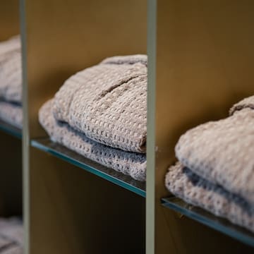 a shelf with folded blankets