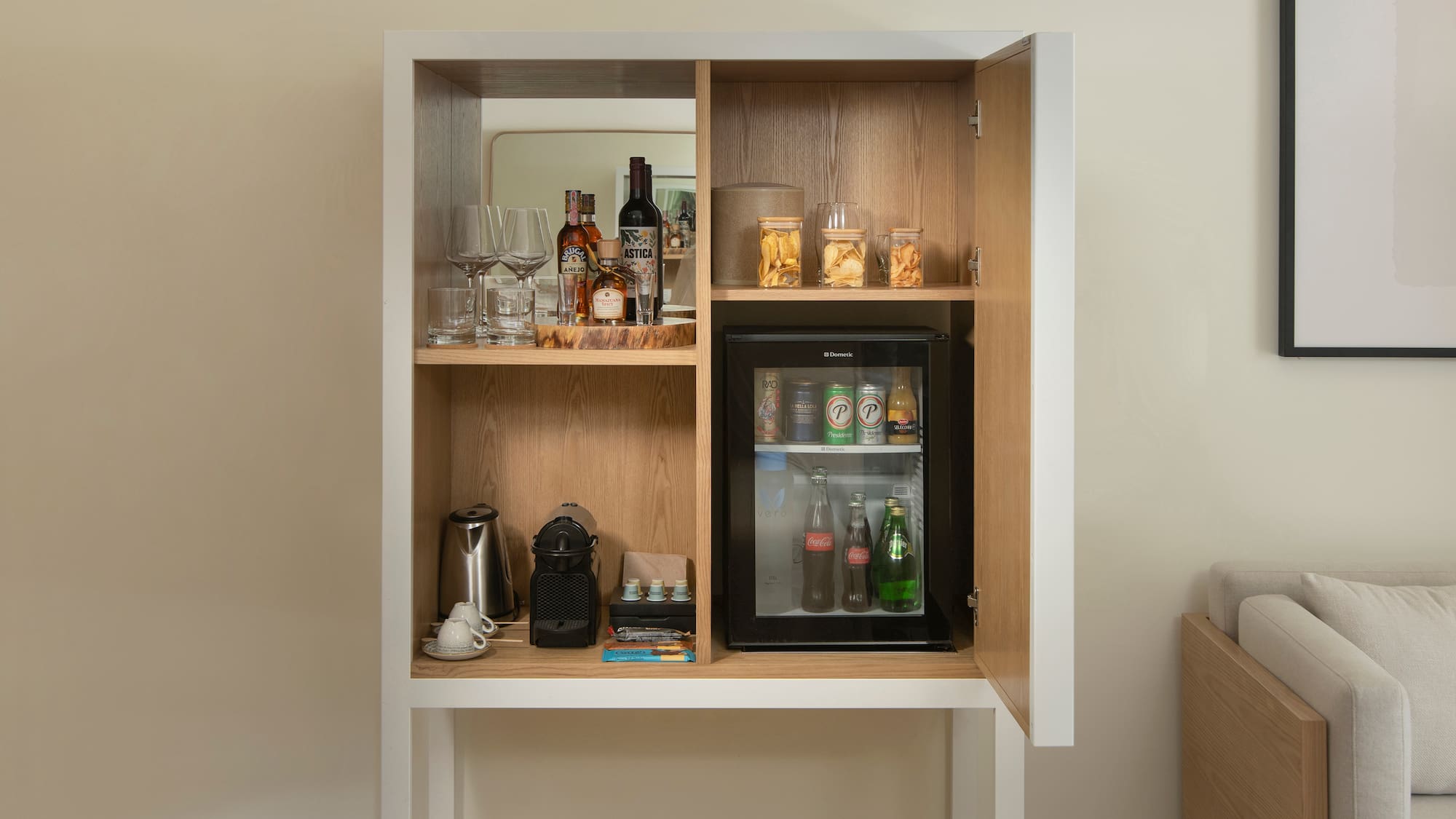 a cabinet with a mini fridge and drinks