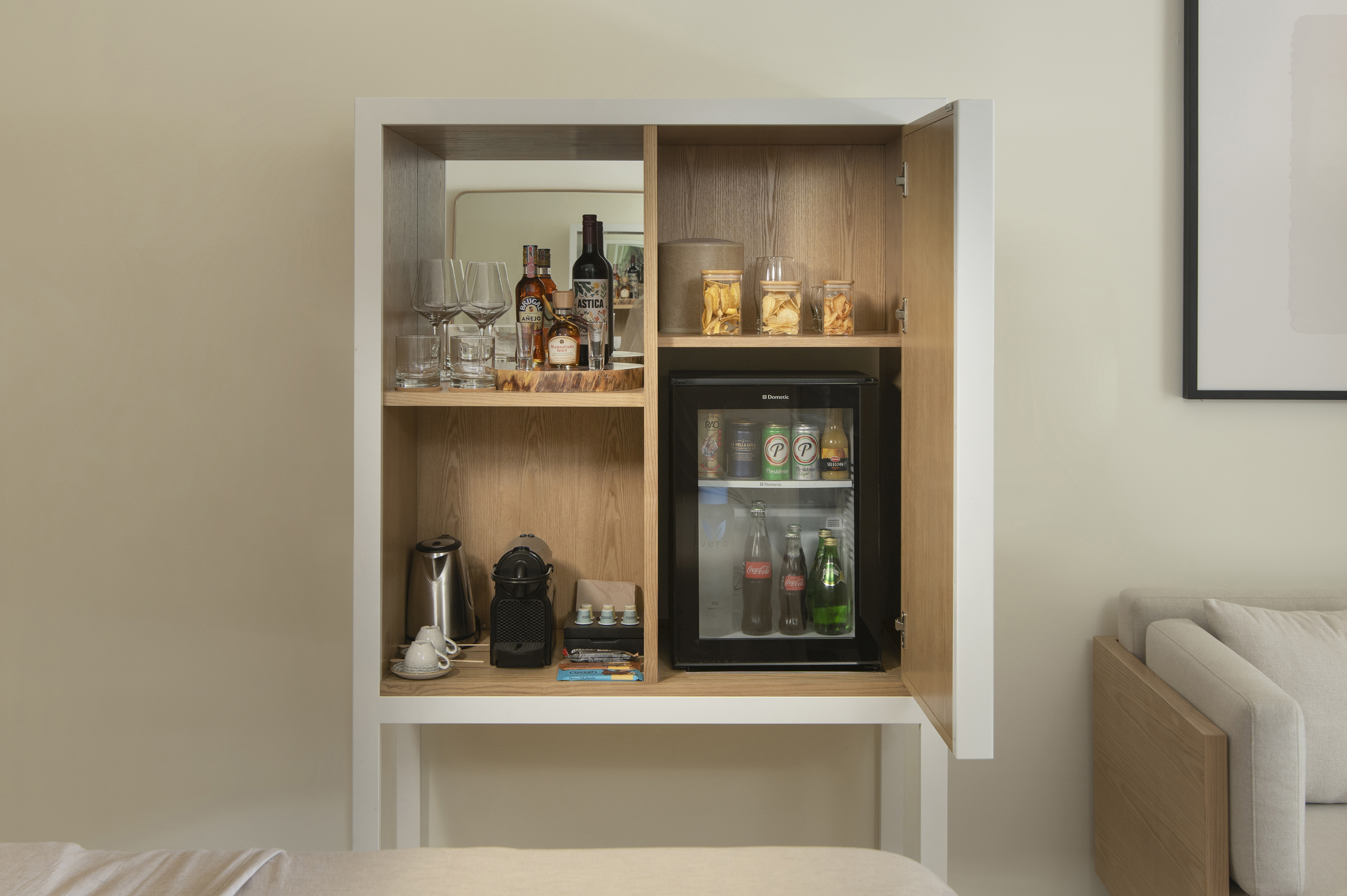a cabinet with a mini fridge and drinks