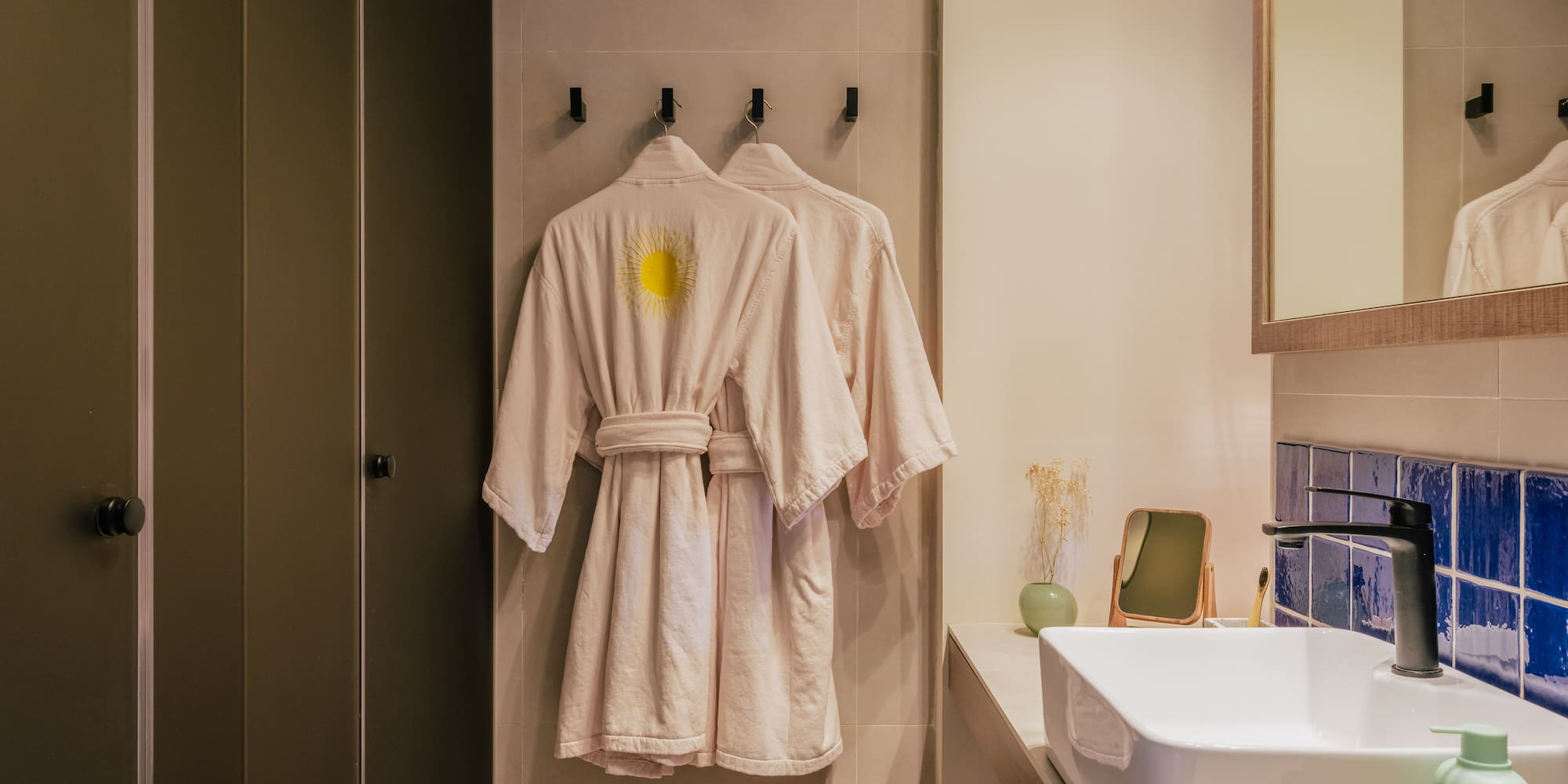 a bathroom with a bathrobe and sink