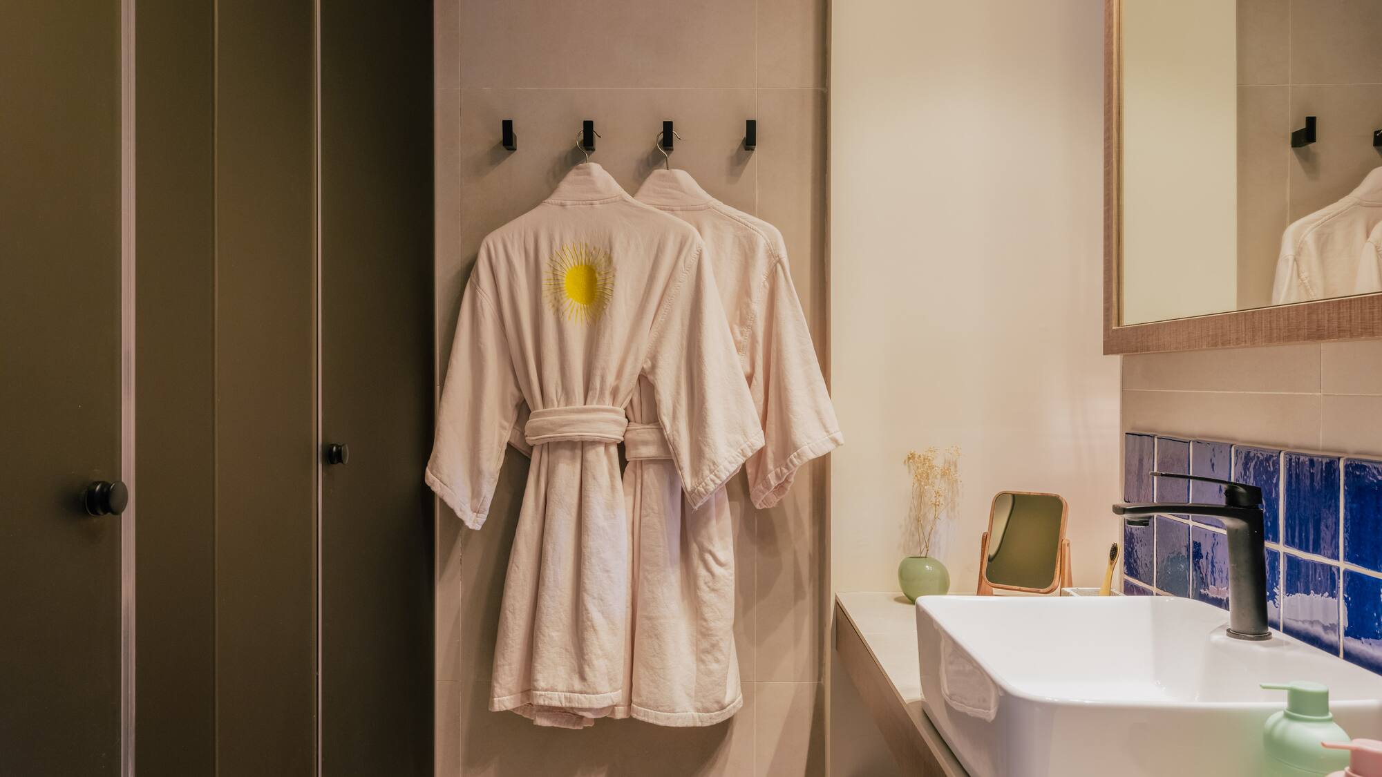 a bathroom with a bathrobe and sink