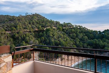 a balcony overlooking a body of water and trees