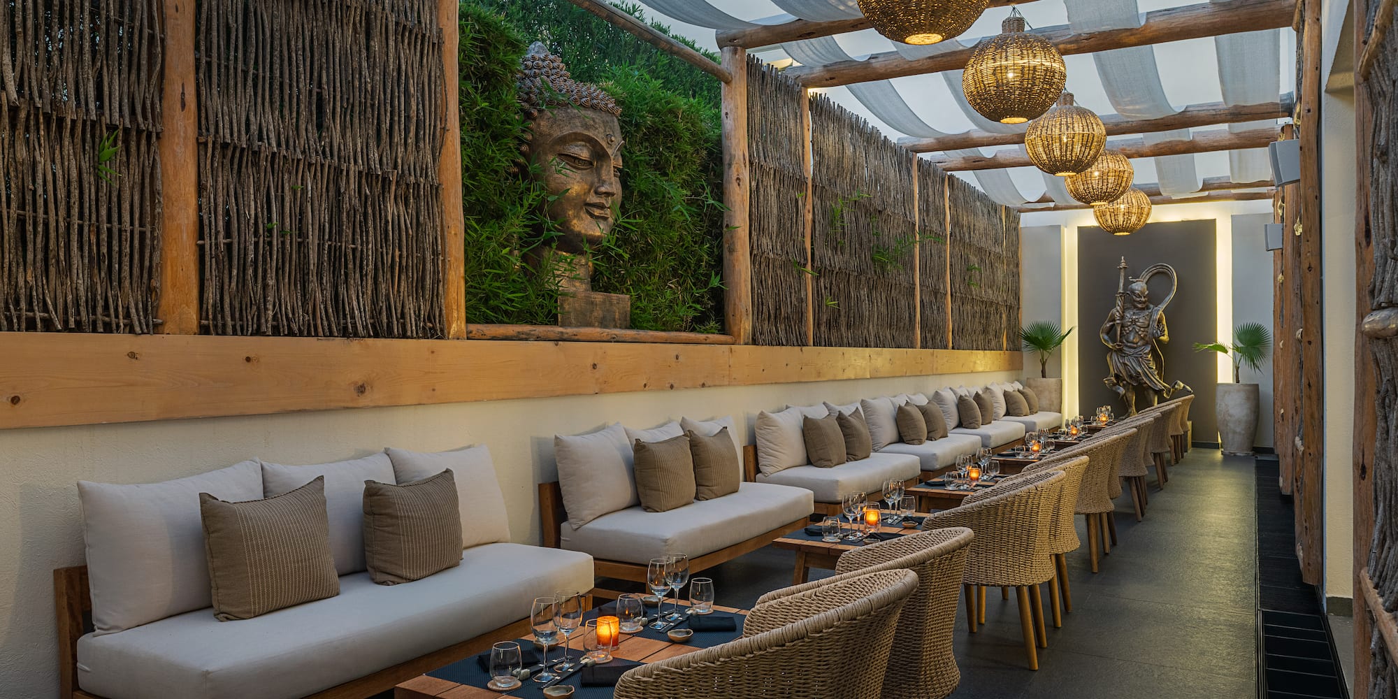 a long outdoor seating area with tables and chairs