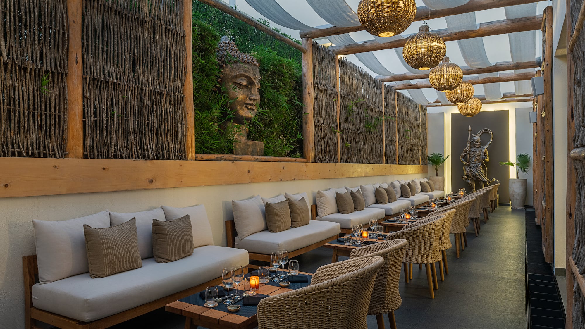 a long outdoor seating area with tables and chairs