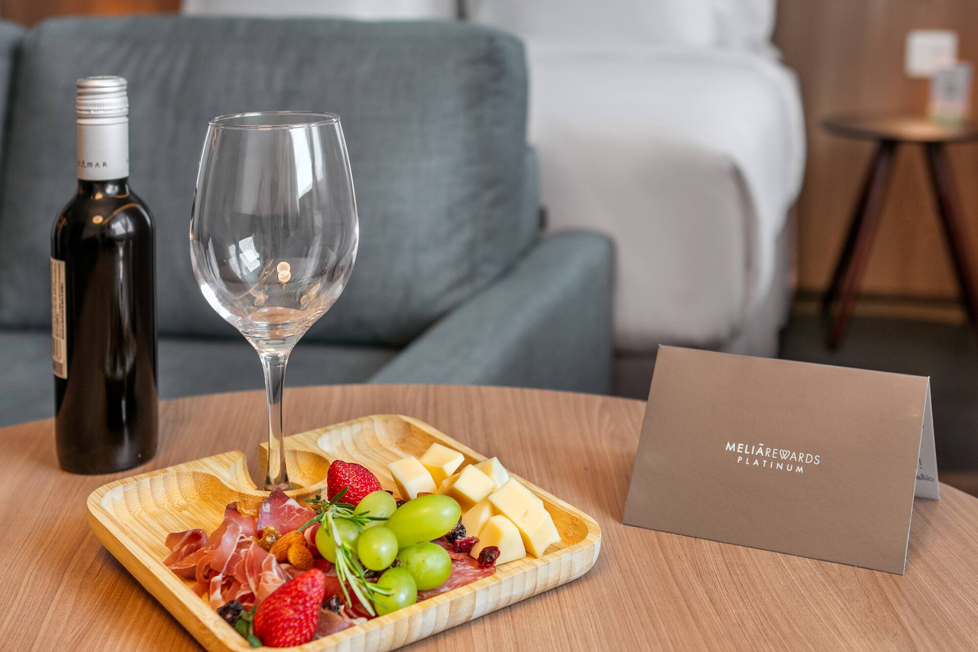 Hotel room welcome: wine, charcuterie platter, MeliáRewards Platinum card.