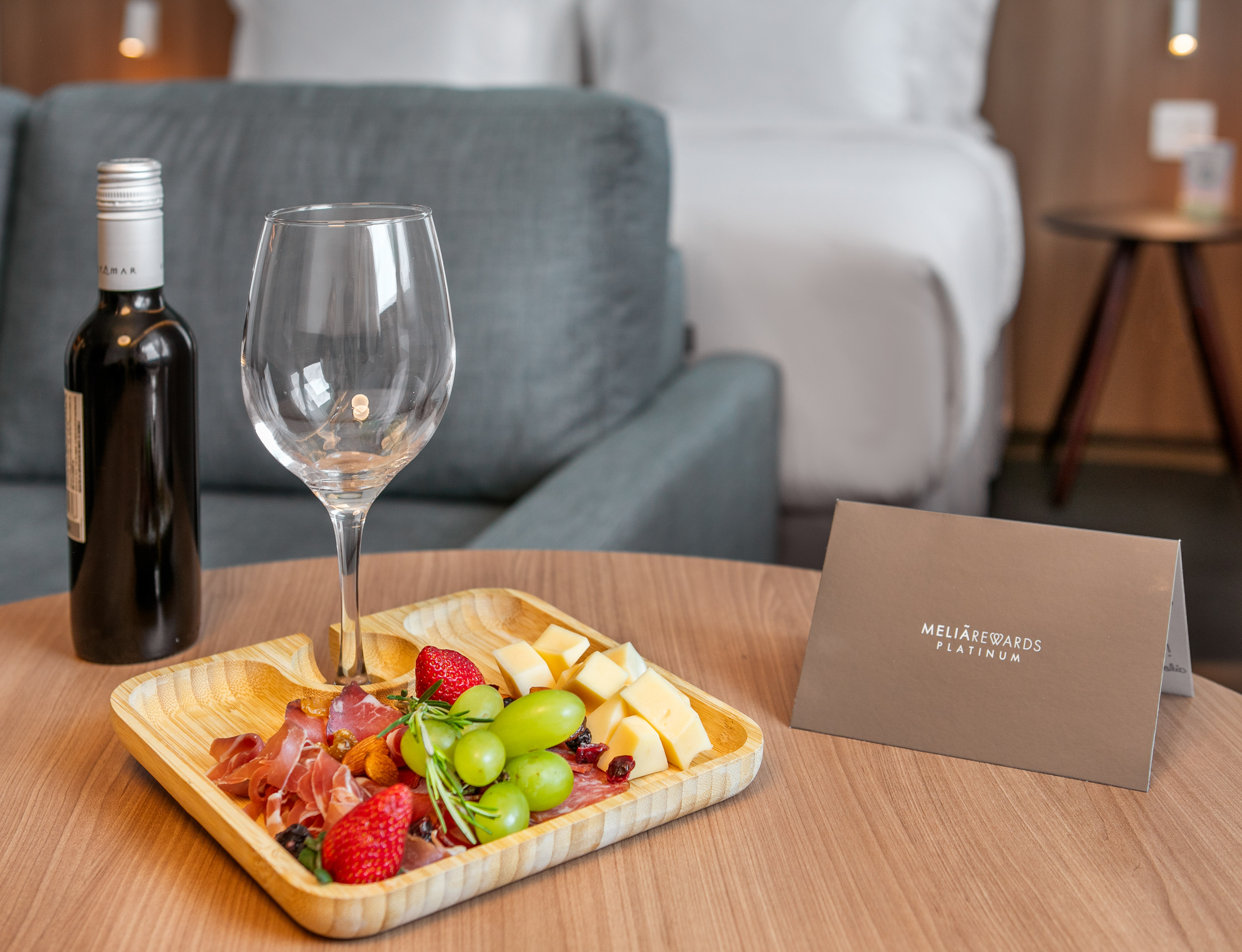 Hotel room welcome: wine, charcuterie platter, MeliáRewards Platinum card.