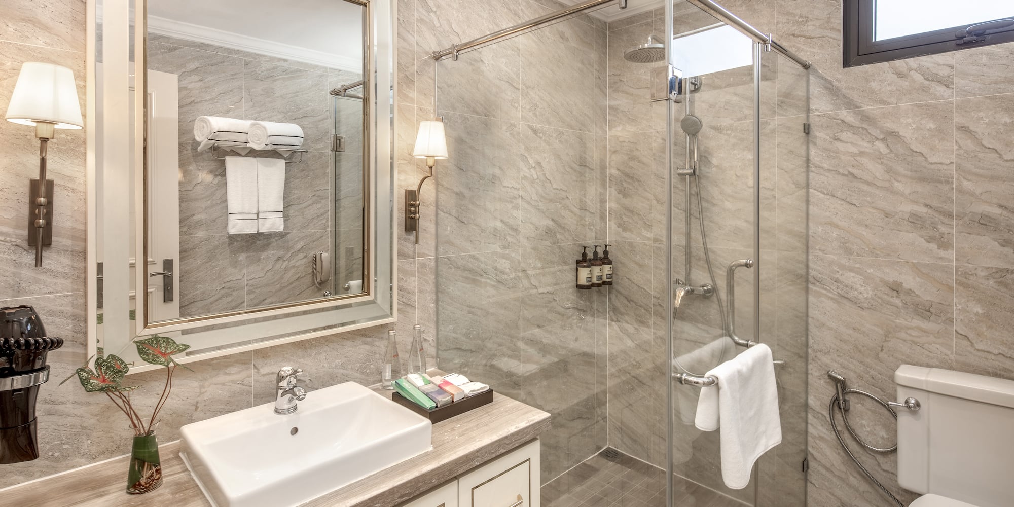 a bathroom with a glass shower and sink