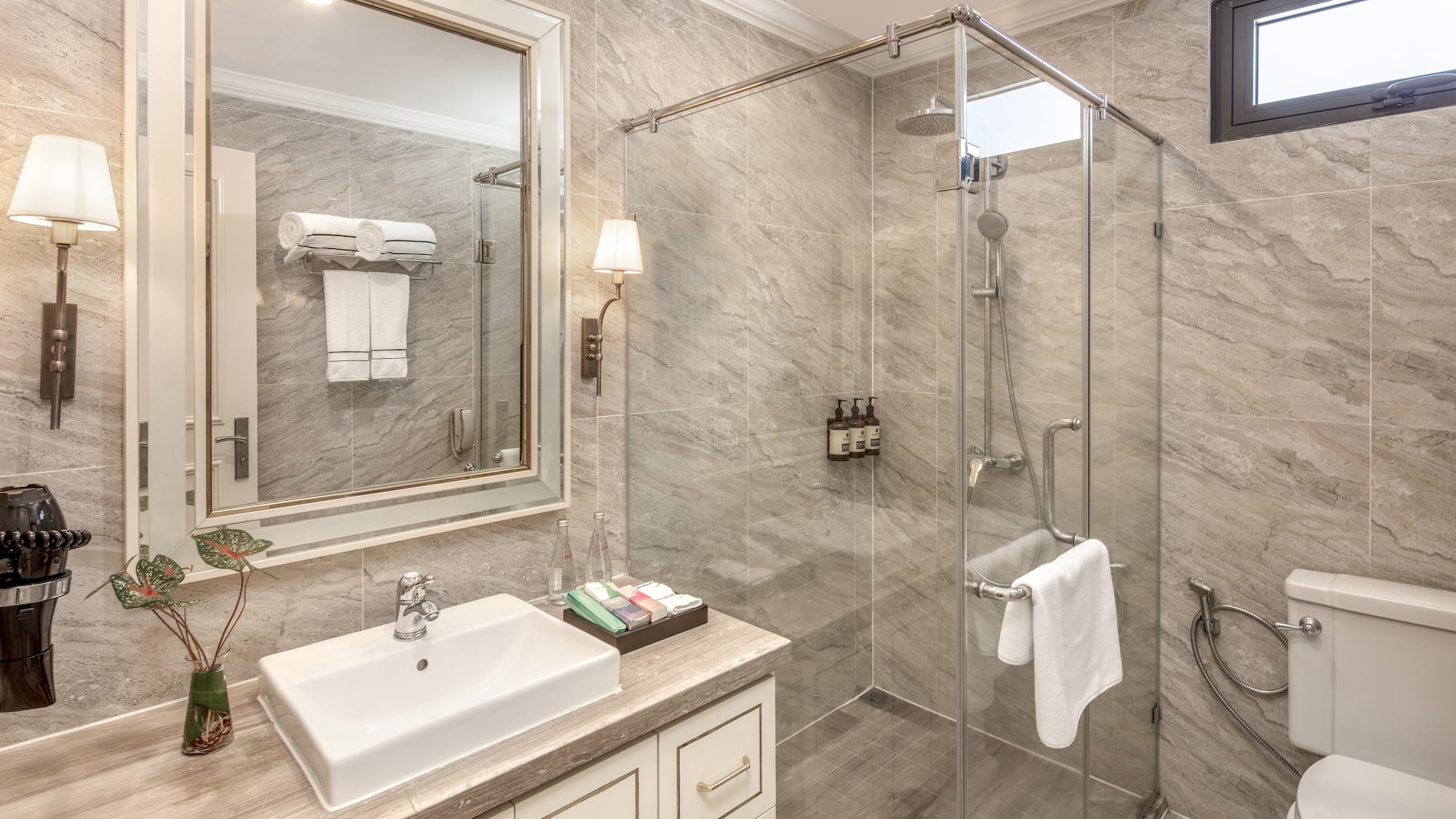 a bathroom with a glass shower and sink