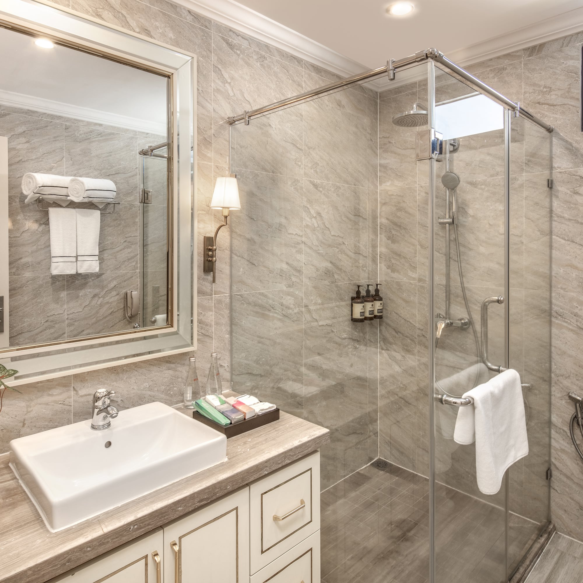 a bathroom with a glass shower and sink
