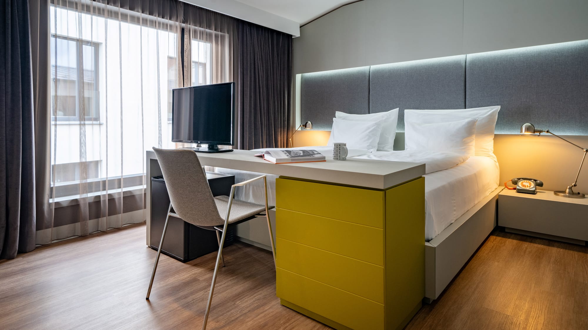 a room with a bed and a desk