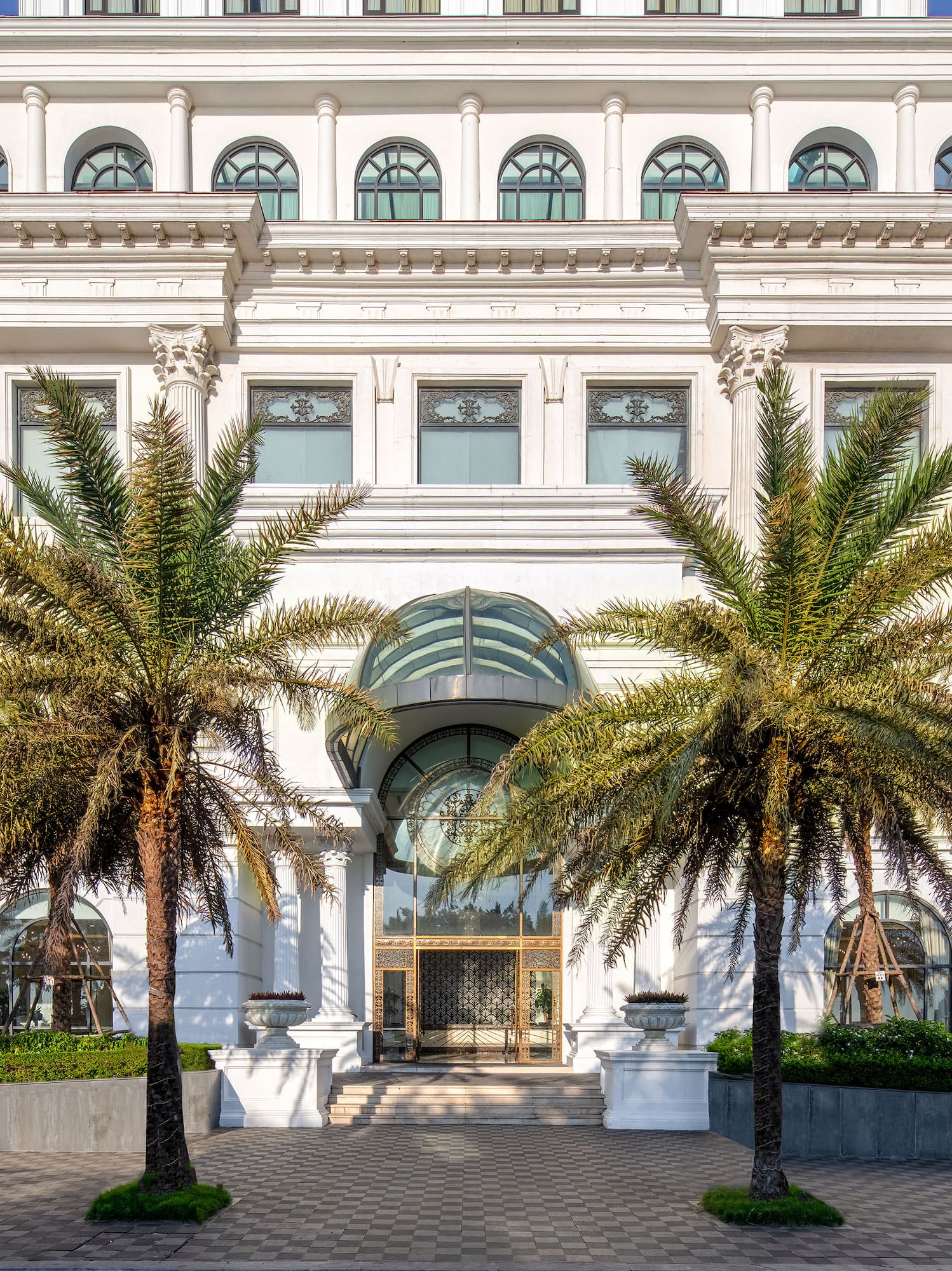 a white building with palm trees