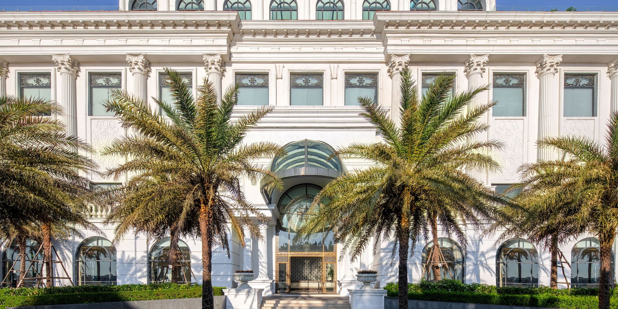 a white building with palm trees