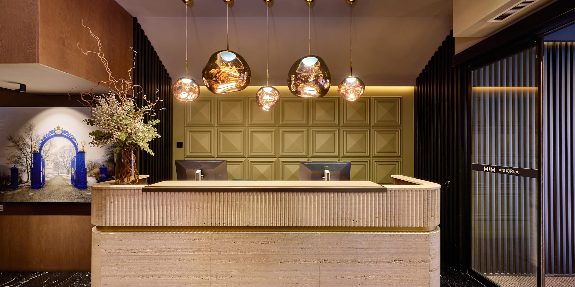 a reception desk with lights from the ceiling