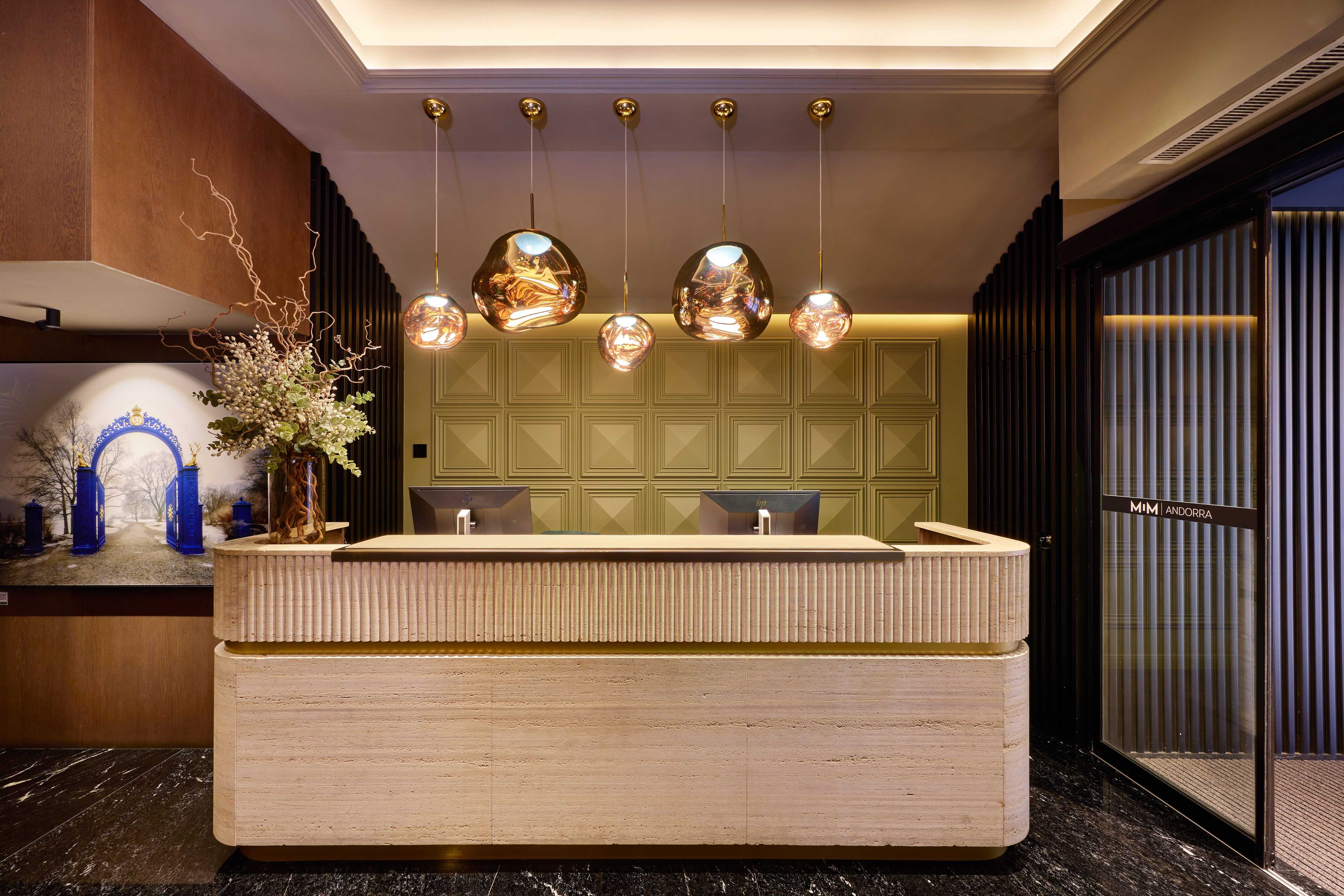 a reception desk with lights from the ceiling
