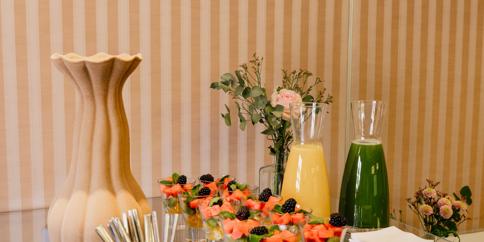 a table with glasses of fruit and juice