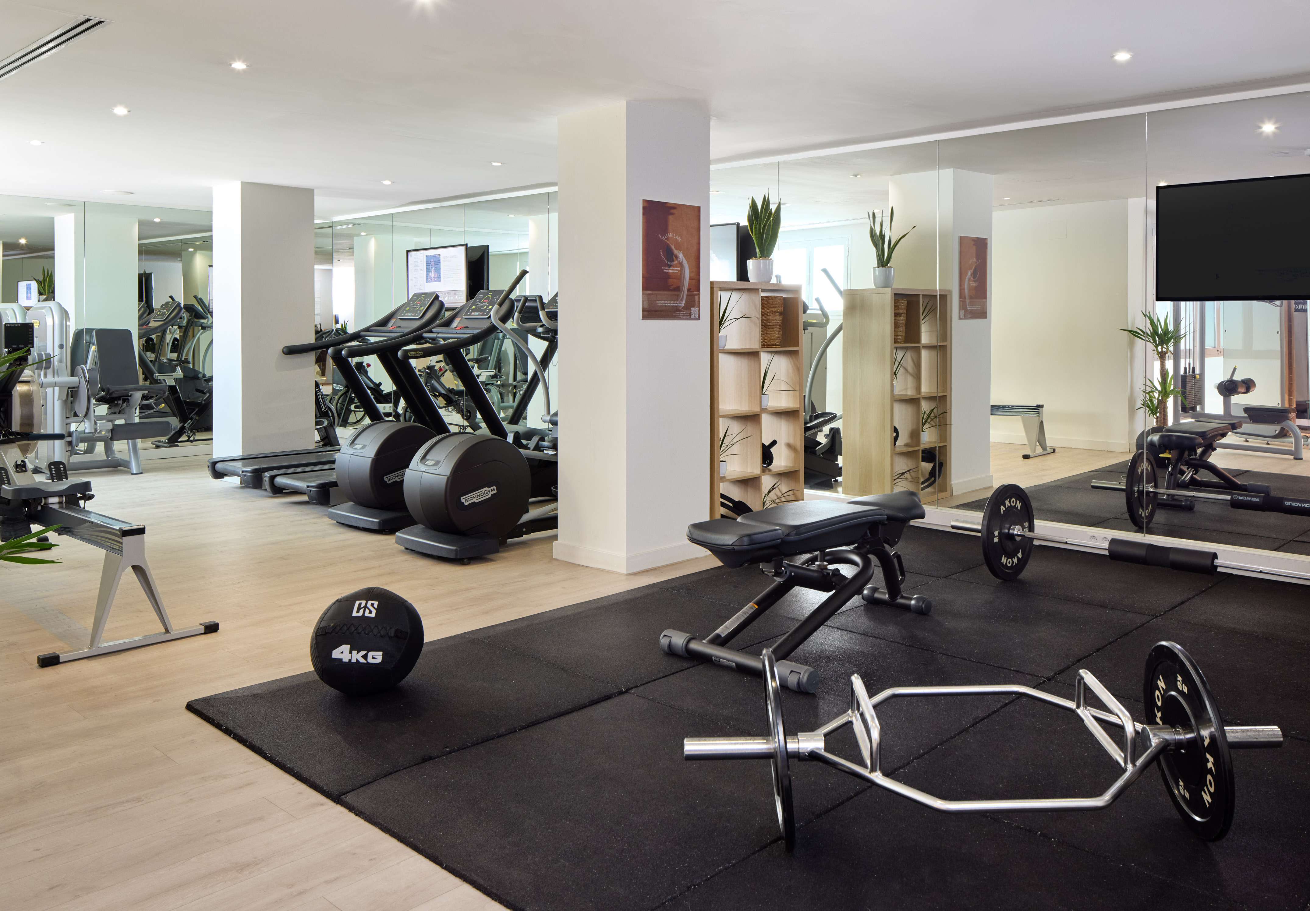 Well-equipped hotel fitness center with treadmills, weights, and cardio machines.