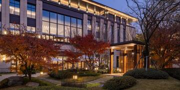 a building with trees and a walkway