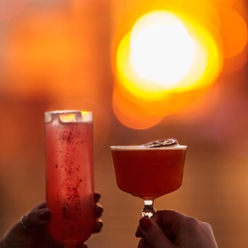 a pair of hands holding drinks