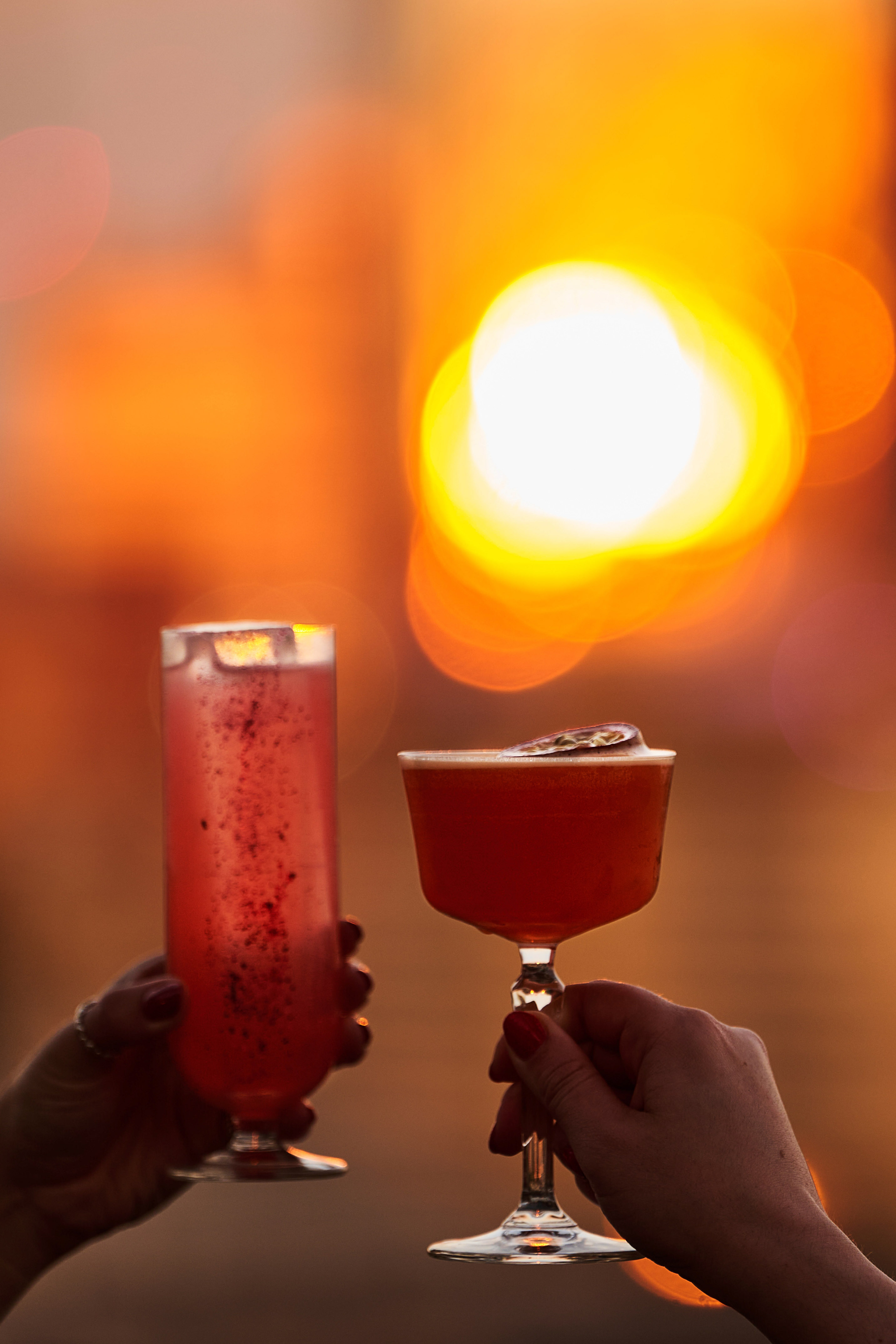 a pair of hands holding drinks