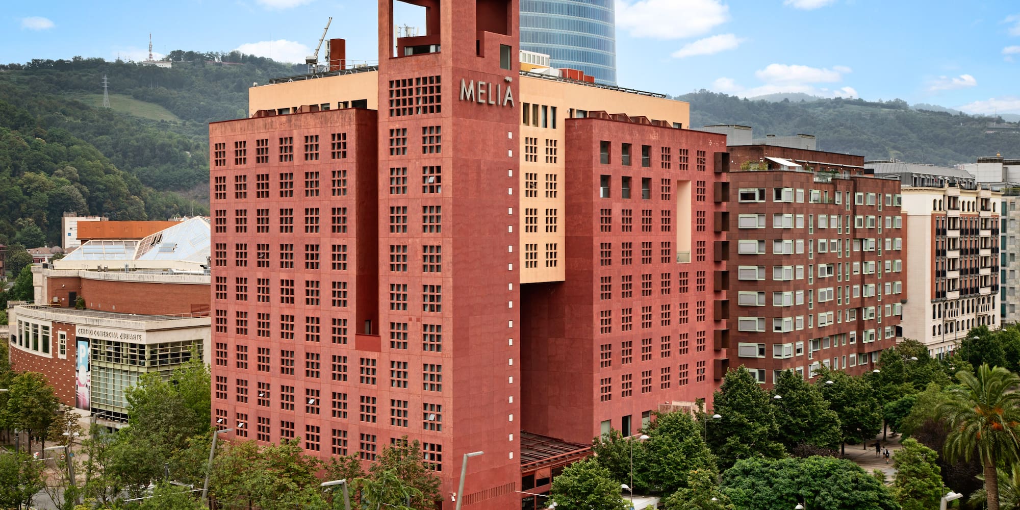 a large red building with trees in front of it