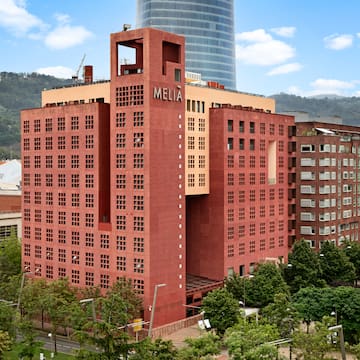 a large red building with trees in front of it