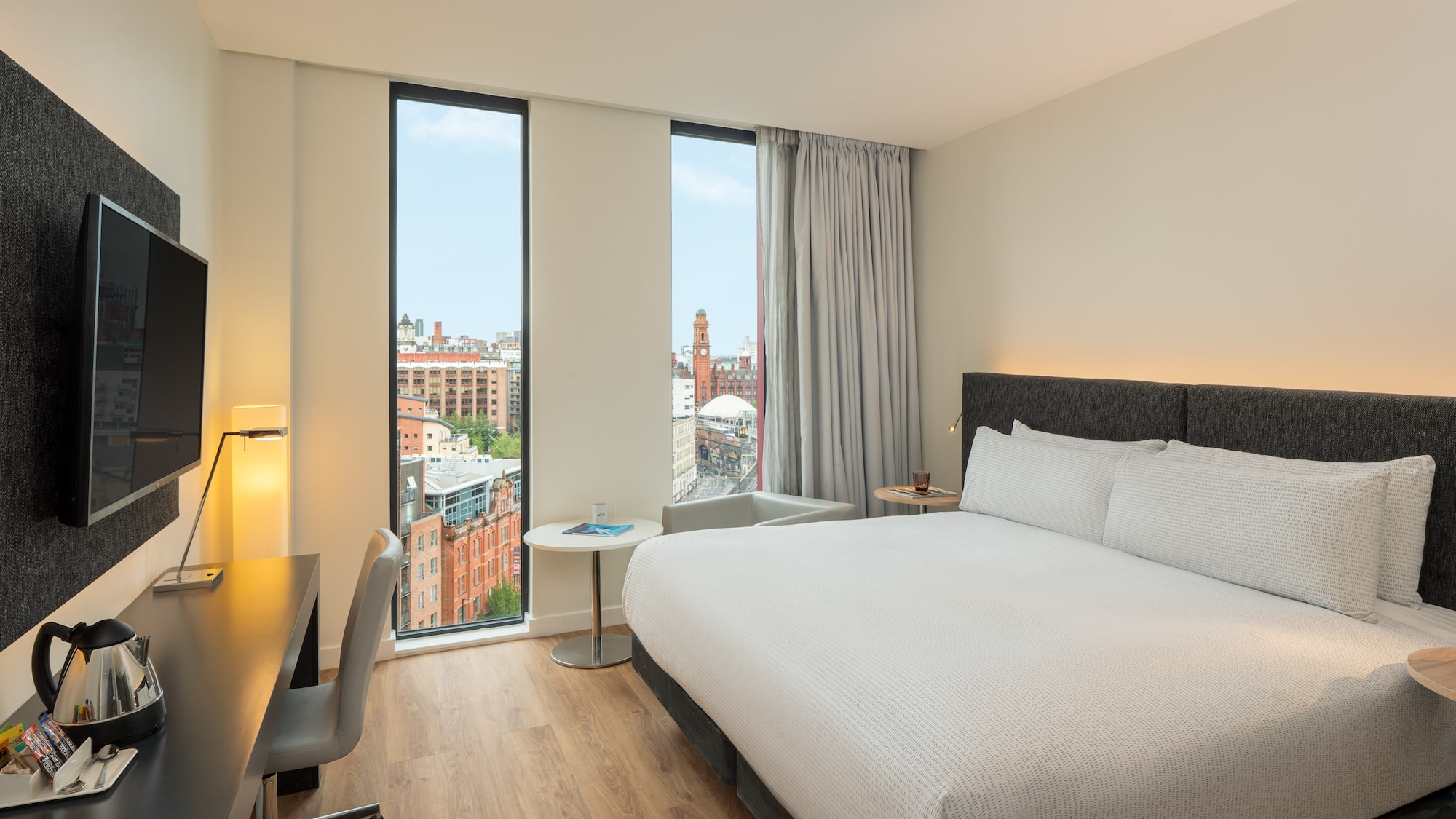 a room with a bed and a desk and a window