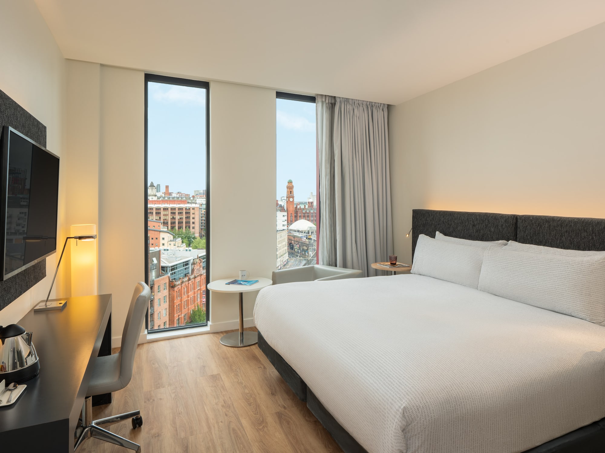 a room with a bed and a desk and a window