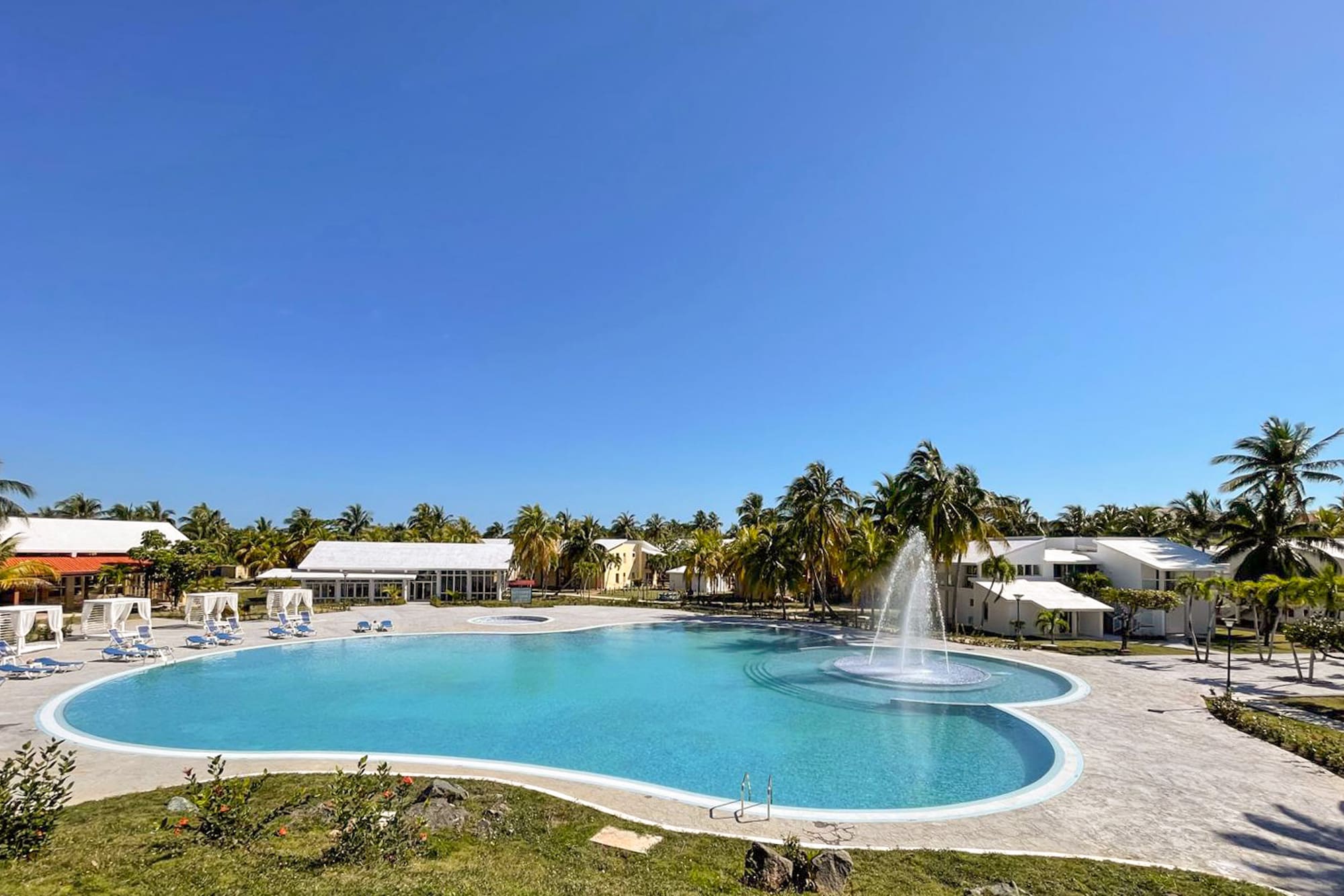 a pool with a fountain in the middle