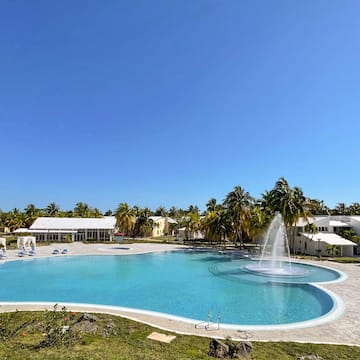 a pool with a fountain in the middle