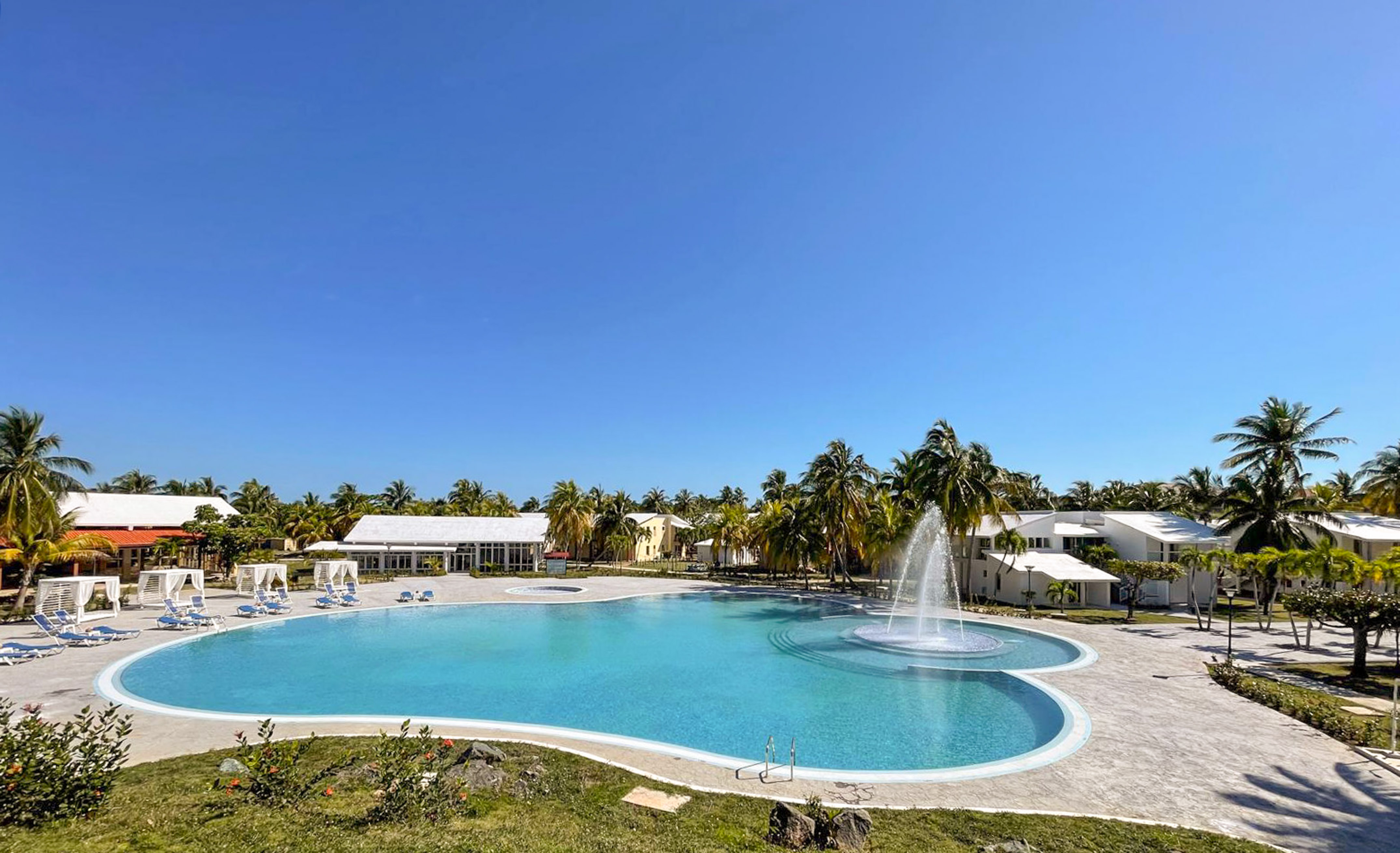 a pool with a fountain in the middle