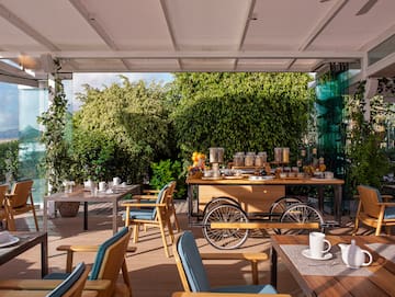 a table with food on it and chairs on a deck