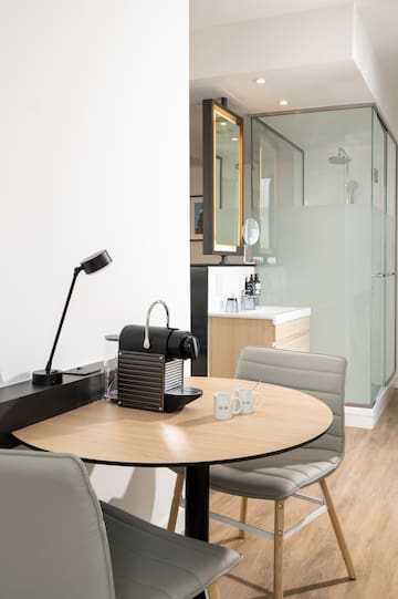 a table with two chairs and a lamp