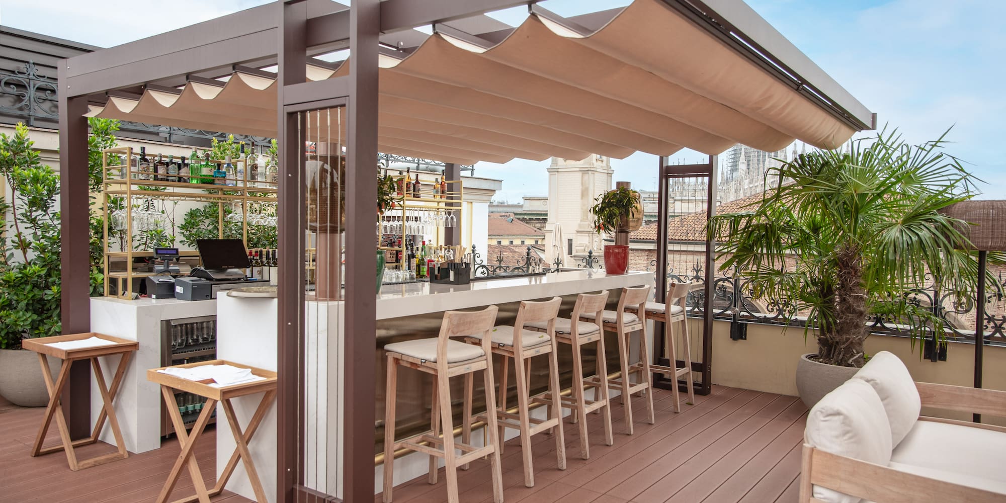 a patio with a bar and chairs