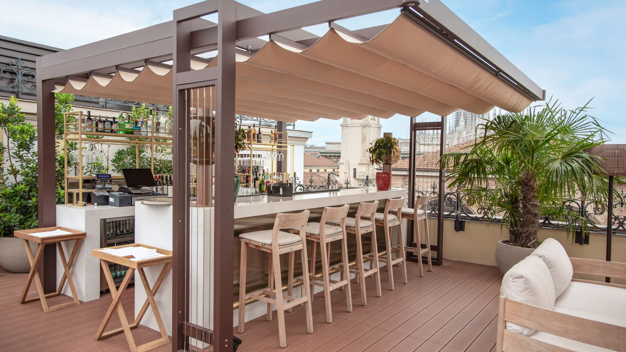 a patio with a bar and chairs