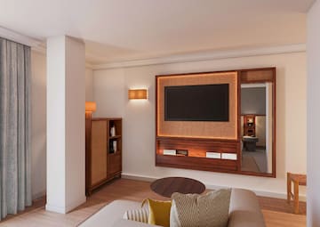 a room with a television and a mirror