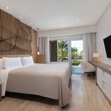 a room with a bed and a television