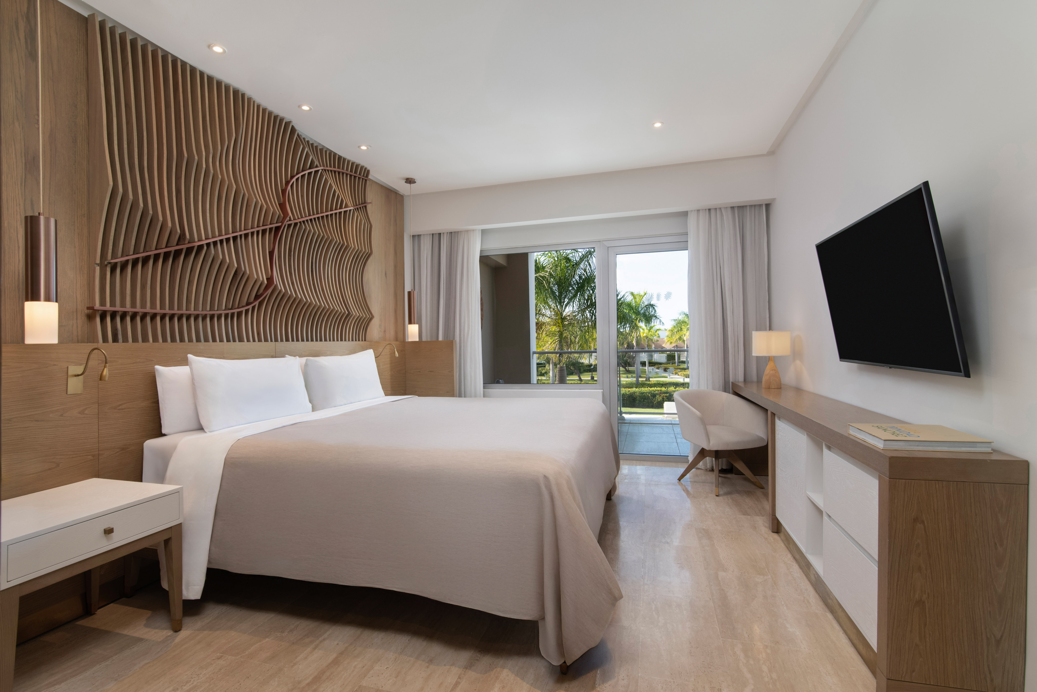 a room with a bed and a television