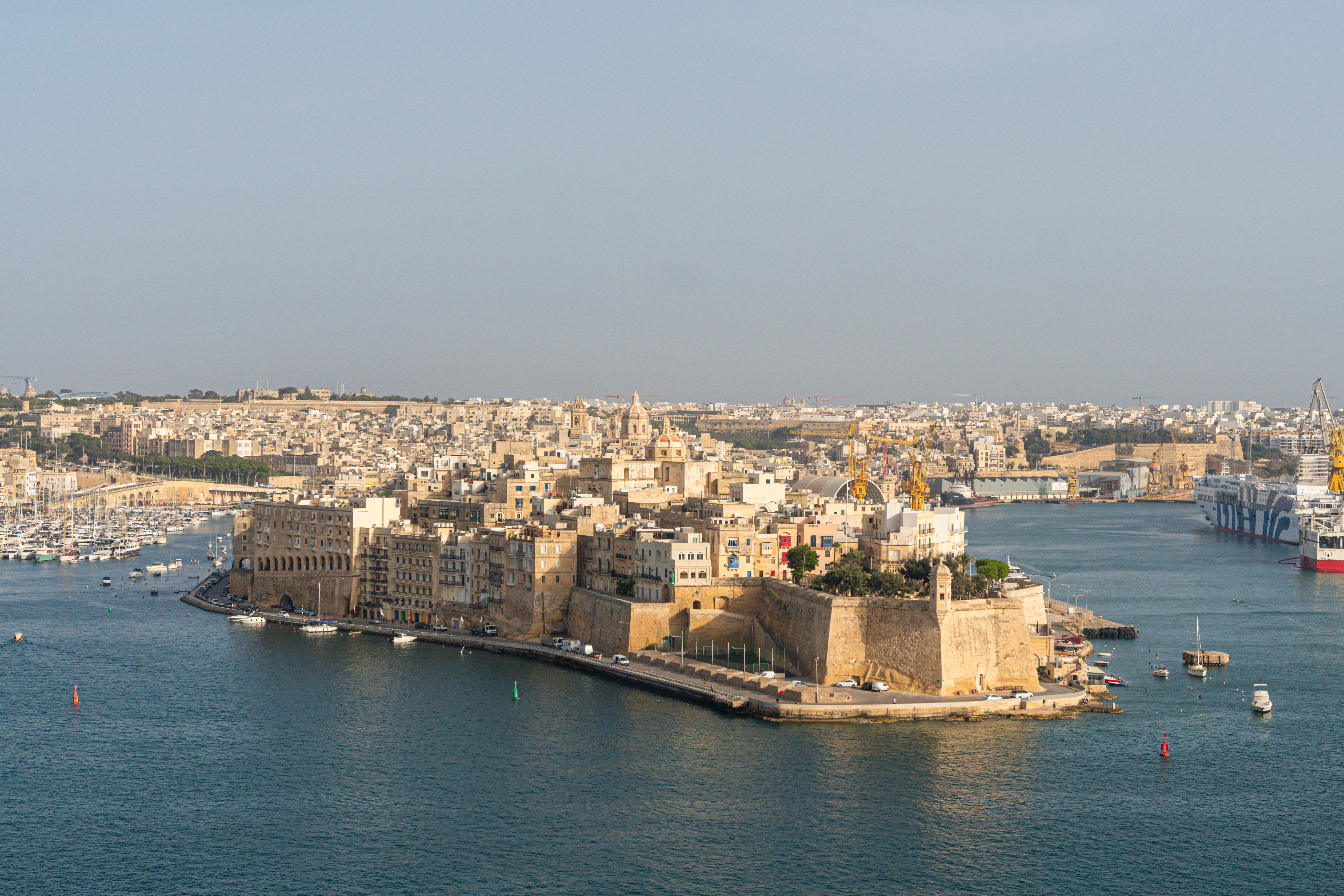 Fortified city of Birgu, Malta, on Grand Harbour with boats.