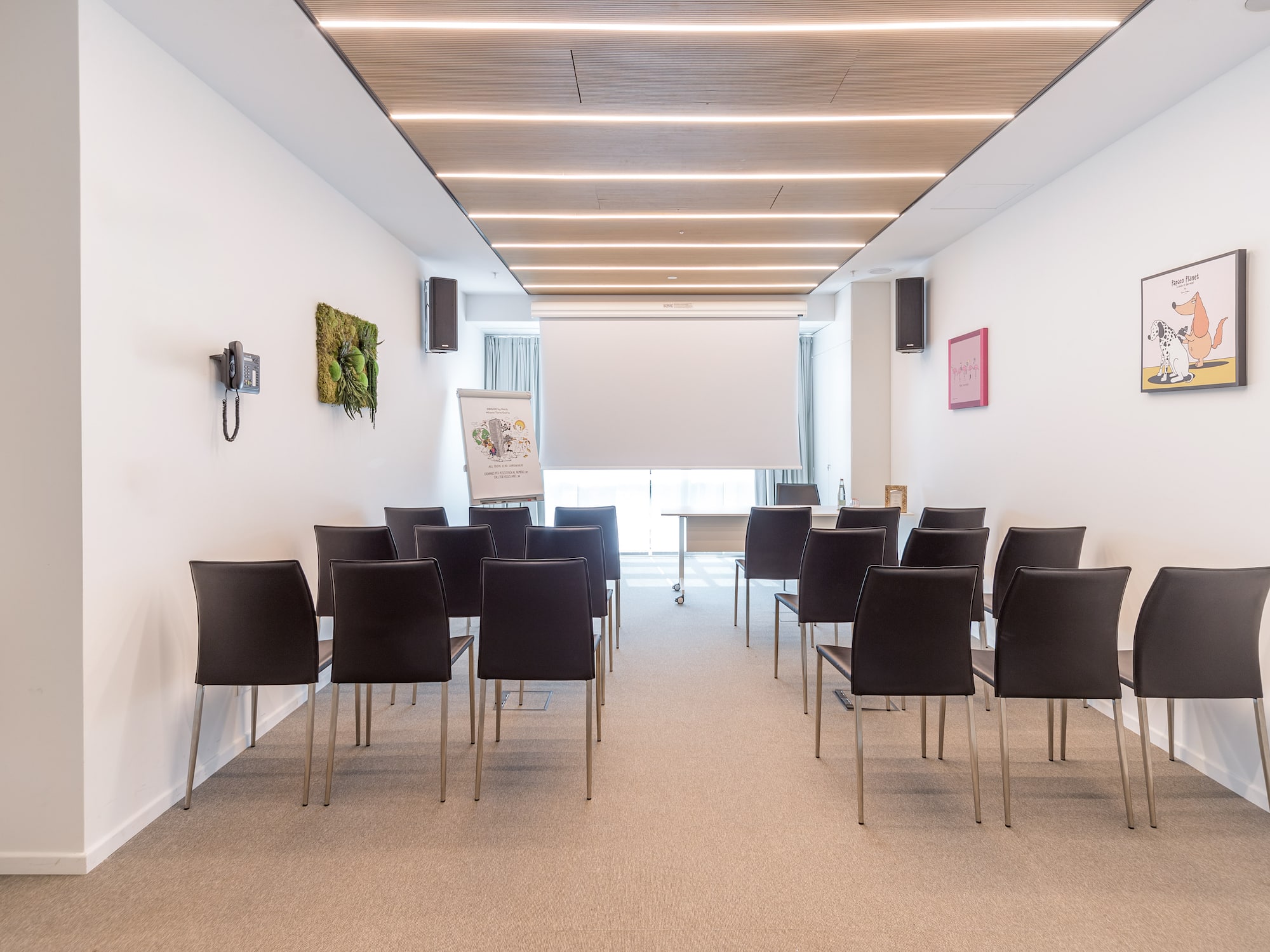 a room with chairs and a projector screen