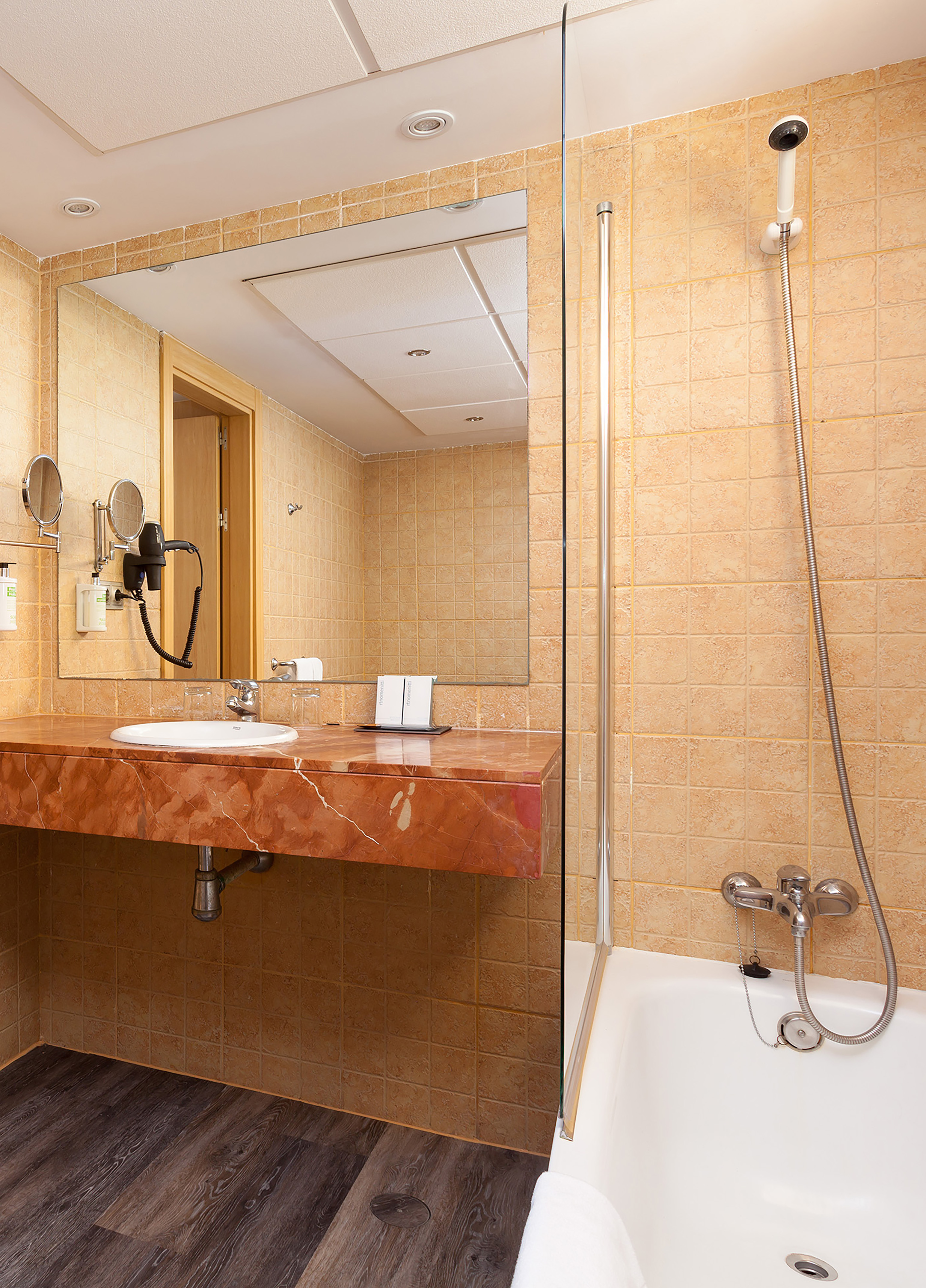 Hotel bathroom with marble vanity, sink, large mirror, and tiled shower tub. - Superior Room - SOL Lanzarote All Inclusive, Lanzarote