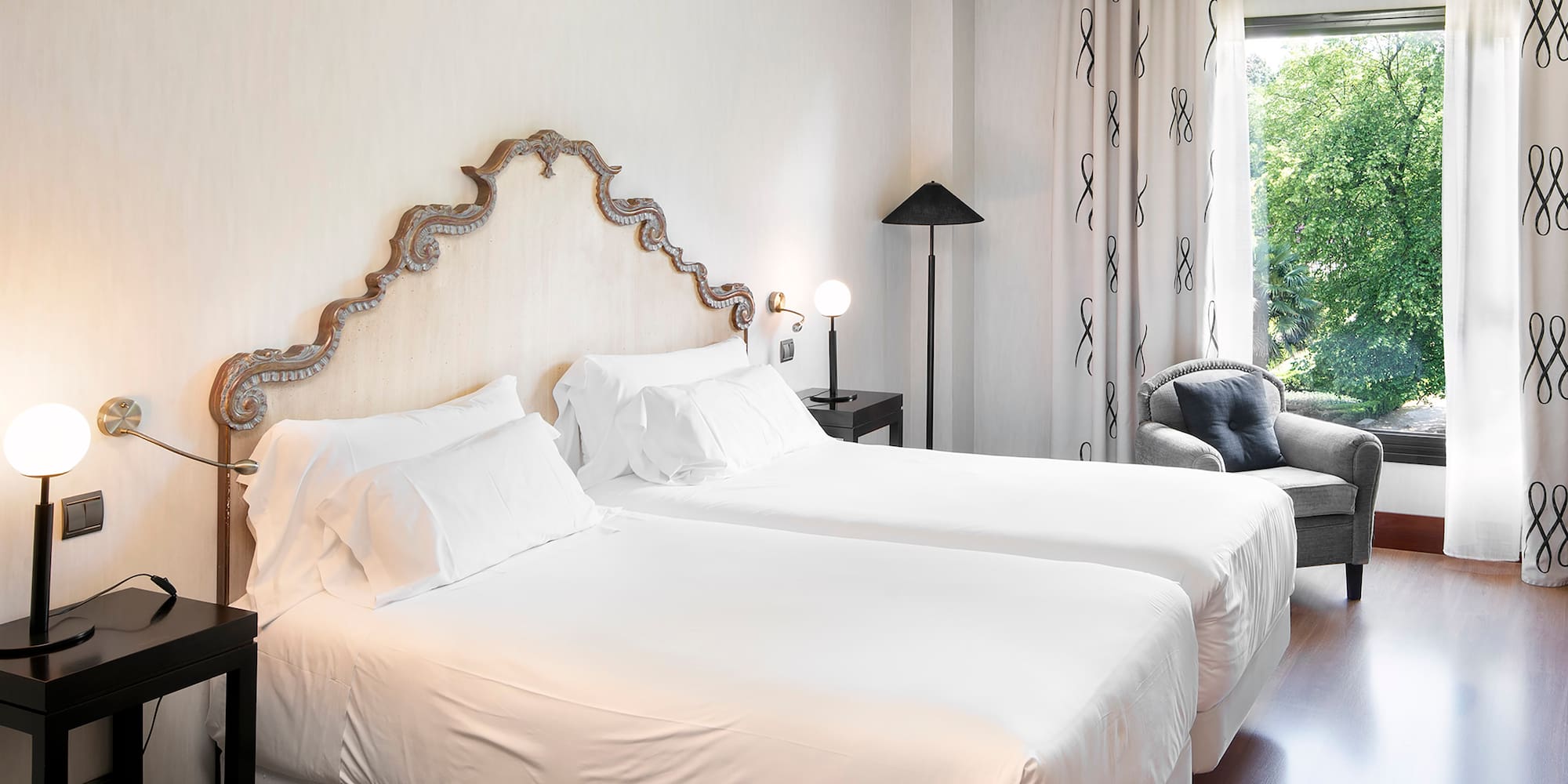 a room with two beds and a chair